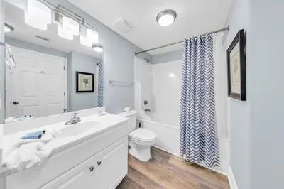 a white bathroom with a sink and a toilet at Majestic Beach Towers 1-1911 in Panama City Beach