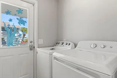 a white washer and dryer in a white kitchen at Beach House - Gulf Dream by Panhandle Getaways in Panama City Beach