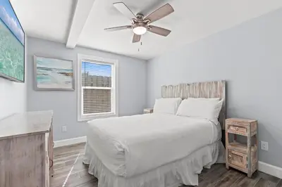 a bedroom with a bed and a ceiling fan at Beach House - Gulf Dream by Panhandle Getaways in Panama City Beach
