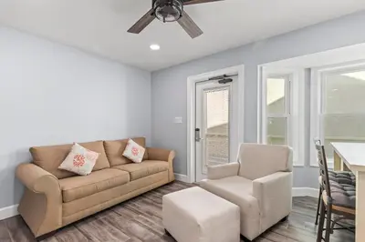 a living room with a couch and a chair at Beach House - Gulf Dream by Panhandle Getaways in Panama City Beach