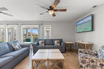 a living room with couches and a ceiling fan at Beach House - Gulf Dream by Panhandle Getaways in Panama City Beach