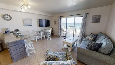 a living room with a couch and a table at Summit 715 in Panama City Beach