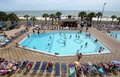 a group of people in a swimming pool at the beach at Summit 715 in Panama City Beach