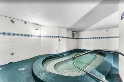 a swimming pool with a hose in a room at Summit 715 in Panama City Beach