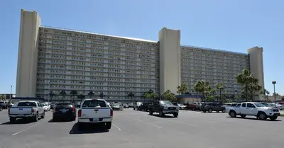 a large building with cars parked in a parking lot at Summit 715 in Panama City Beach
