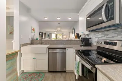 a kitchen with a sink and a stove top oven at Edgewater Gulf Villas 953 in Panama City Beach