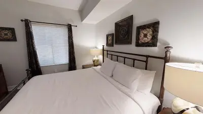 a bedroom with a large white bed and a window at Tidewater 3011 in Panama City Beach