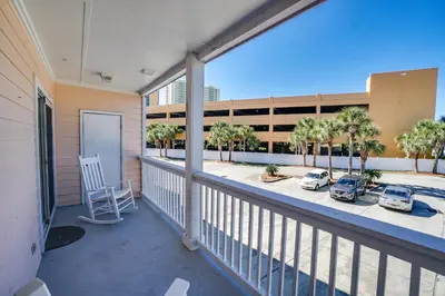 a balcony with cars parked in a parking lot at Peachtree Place Condominiums by Panhandle Getaways in Panama City Beach
