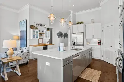 a kitchen with white cabinets and a kitchen island at 30A Pet Friendly Beach House - 33 Sunset by Panhandle Getaways in Rosemary Beach