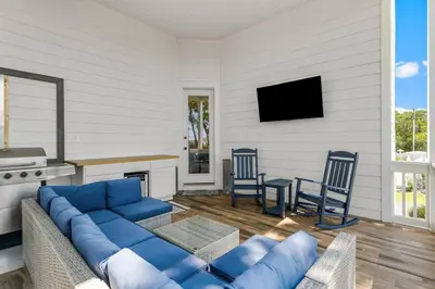 a living room with a blue couch and chairs at 30A Pet Friendly Beach House - 33 Sunset by Panhandle Getaways in Rosemary Beach