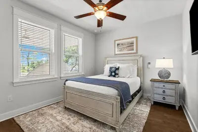 a bedroom with a bed and a ceiling fan at 30A Pet Friendly Beach House - 33 Sunset by Panhandle Getaways in Rosemary Beach