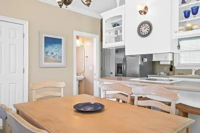 a kitchen and dining room with a table and chairs at Summer Towne by Panhandle Getaways in Panama City Beach