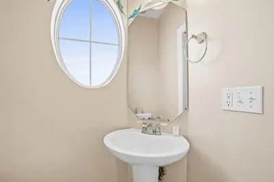 a bathroom with a white sink and a mirror at Summer Towne by Panhandle Getaways in Panama City Beach