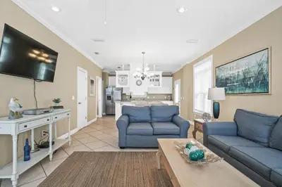 a living room with two blue couches and a table at Summer Towne by Panhandle Getaways in Panama City Beach