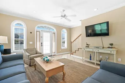 a living room with a couch and a tv at Summer Towne by Panhandle Getaways in Panama City Beach