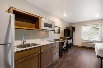 a kitchen with a sink and a microwave at WoodSpring Suites Panama City Beach in Panama City Beach