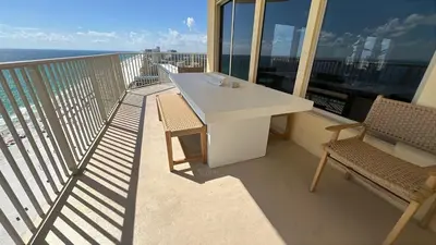 a balcony with a white table and two chairs at Gulf Crest 2107A in Panama City Beach