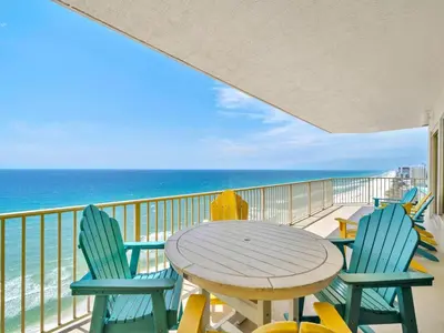 a table and chairs on a balcony with the ocean at Gulf Crest 2107A in Panama City Beach