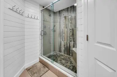 a shower with a glass door in a bathroom at Gulf Crest 2107A in Panama City Beach