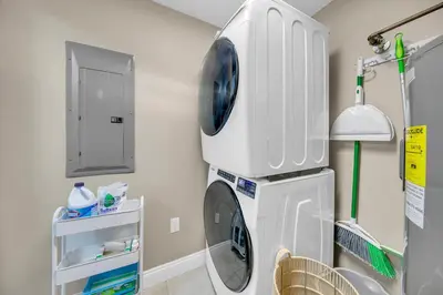 a bathroom with a washing machine in a room at Gulf Crest 2107A in Panama City Beach