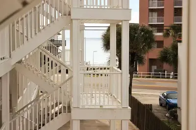 a white stairway in a building next to a street at Across the Street from beach with 2 pools in Panama City Beach