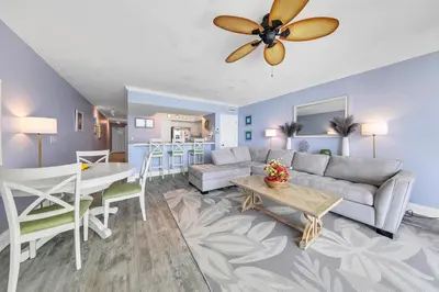 a living room with a couch and a table at Emerald Beach 1035 in Panama City Beach