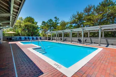 a large swimming pool on a brick patio at Magnolia Cottage in Inlet Beach