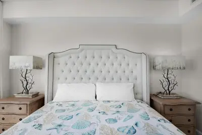 a bedroom with a large bed with two night stands at Aqua Resort 2103 in Panama City Beach
