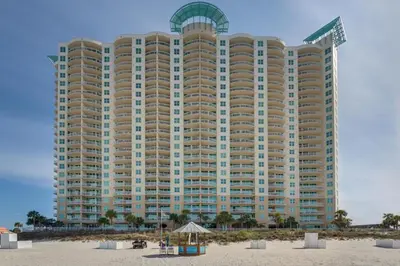 a large building on the beach in front of a building at Aqua Resort 2103 in Panama City Beach