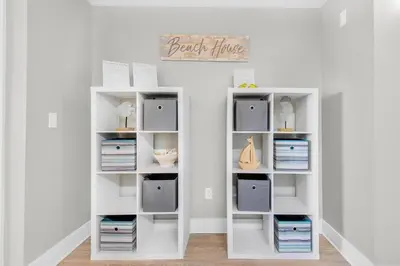 a white book shelf in a room at Calypso 3-406 - Paradise by the Pier in Panama City Beach