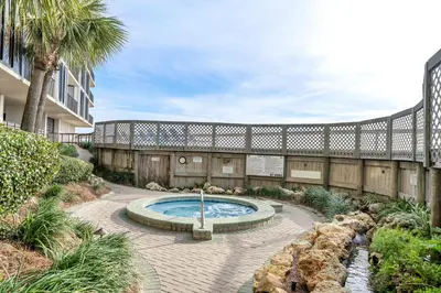 a courtyard with a swimming pool and a building at Edgewater Tower 2-404 in Panama City Beach