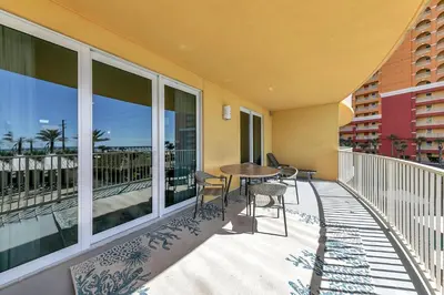 a balcony with a table and chairs on it at Calypso 3-202 - The Sea Suite in Panama City Beach