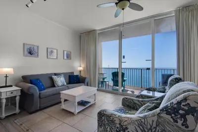 a living room with a view of the ocean at Tidewater 3013 in Panama City Beach