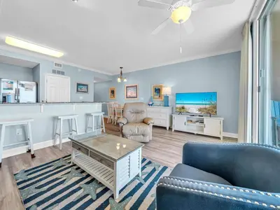 a living room with a couch and a table at Tidewater 607 in Panama City Beach