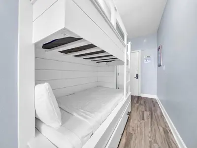a white bunk bed in a white room at Tidewater 607 in Panama City Beach