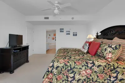 a bedroom with a bed and a tv on a dresser at Tidewater 901 in Panama City Beach