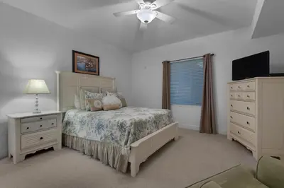 a bedroom with a bed and a ceiling fan at Tidewater 901 in Panama City Beach