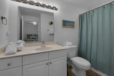 a bathroom with a sink and a toilet and a shower at Tidewater 901 in Panama City Beach