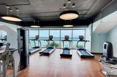 a gym with a row of treadmills at Splash 603E in Panama City Beach