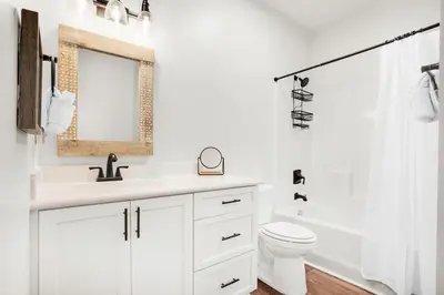 a white bathroom with a sink and a toilet at Pearl Flamingo in Panama City Beach