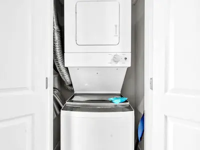 a white washer and dryer in a closet at Edgewater Tower 1-305 in Panama City Beach