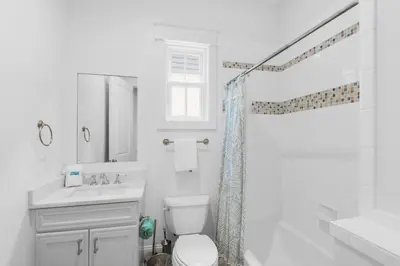 a white bathroom with a toilet and a sink at Churchill Dunes in Inlet Beach