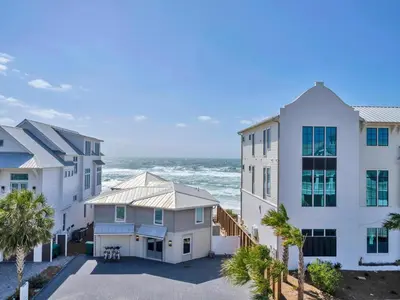 a group of buildings next to the ocean at Churchill Dunes in Inlet Beach