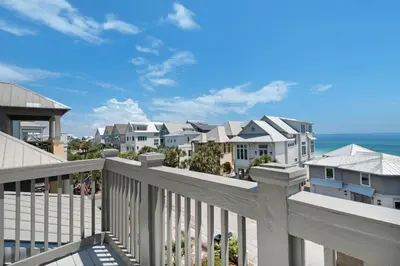 a view of the beach from the balcony of a house at Churchill Dunes in Inlet Beach