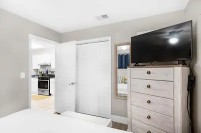 a bedroom with a dresser with a flat screen tv on it at Gulf Highlands 116H in Panama City Beach