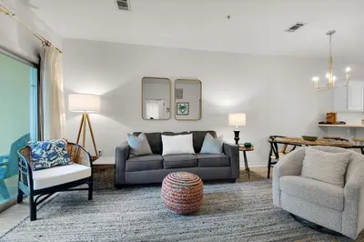 a living room with a couch and a chair at Heron's Watch Way 4104- Coach's Sand Dollar in Santa Rosa Beach