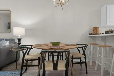 a dining room table with chairs and a kitchen at Heron's Watch Way 4104- Coach's Sand Dollar in Santa Rosa Beach