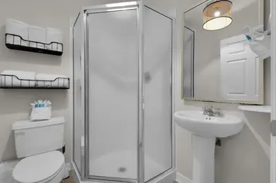 a bathroom with a shower and a toilet and a sink at Heron's Watch Way 4104- Coach's Sand Dollar in Santa Rosa Beach