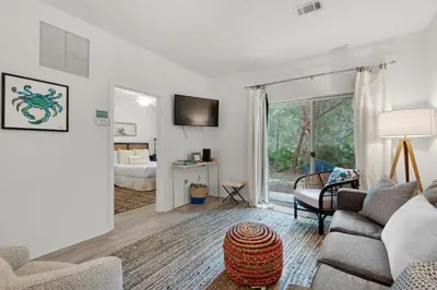 a living room with a couch and a bed at Heron's Watch Way 4104- Coach's Sand Dollar in Santa Rosa Beach