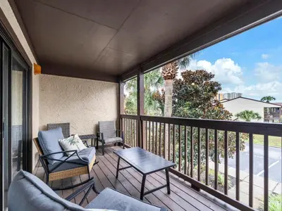 a balcony with chairs and a table and a view at Portside R4 in Panama City Beach